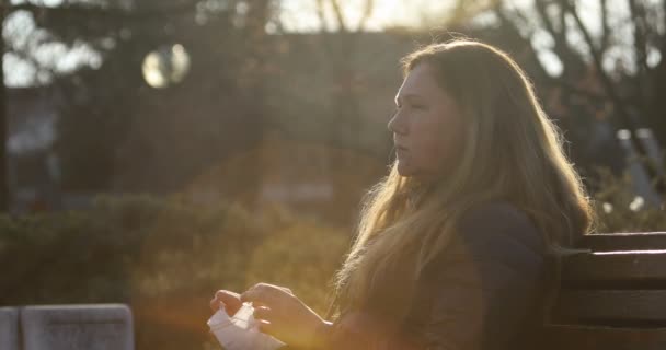 Woman Puts Mask Protection Coronavirus Covid Woman Sitting Bench Sunny — Stock Video