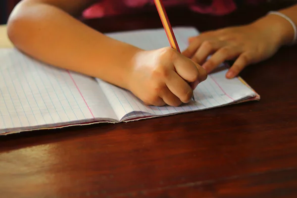 Young Hand Writing Lesson Pencil Book Wooden Table Student Doing — Stockfoto