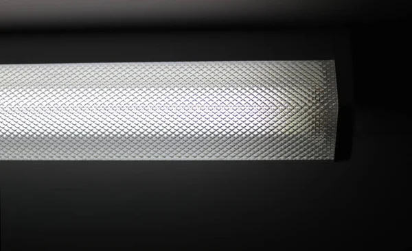 Fluorescent light tube in a ceiling\'s room. Electric lamp and energy power concept