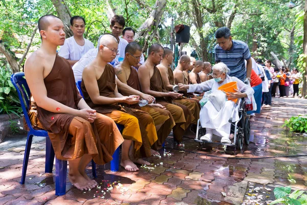 People celebrate Songkran by pouring water for buddhist priest — Stock Photo, Image