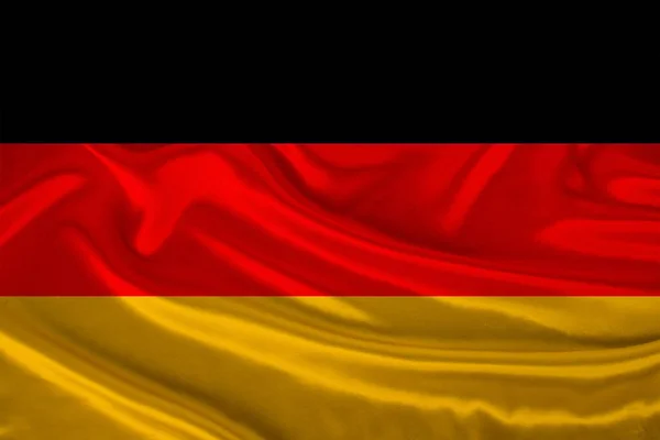 Foto de la bandera nacional de Alemania en una textura lujosa de satén, seda con olas, pliegues y reflejos, primer plano, espacio para copiar, concepto de viaje, economía y política de estado, ilustración —  Fotos de Stock