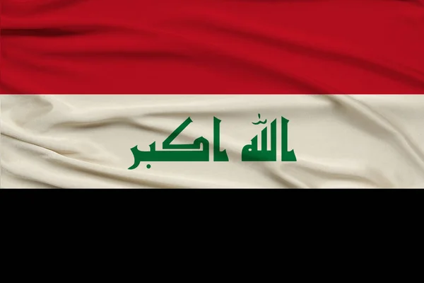 Beautiful photo of the colored national flag of the modern state of Iraq on textural fabric, concept of tourism, emigration, economy and politics, close up — Stock Photo, Image