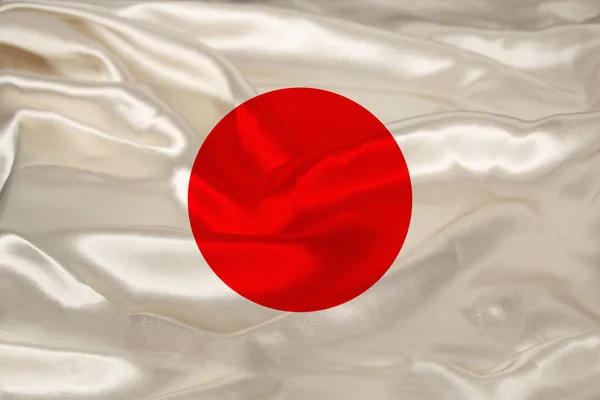 Foto della bella bandiera nazionale colorata dello stato moderno del Giappone su tessuto strutturato, concetto di turismo, emigrazione, economia e politica, primo piano — Foto Stock