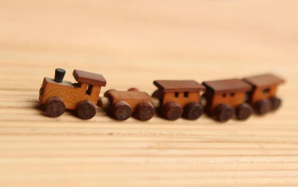 Wooden toy train with wagons on a light background, the concept of children's toys, transport — Stock Photo, Image