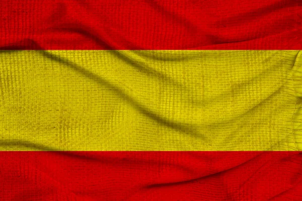 Foto de la hermosa bandera nacional de color del estado moderno de España en un tejido texturizado, concepto de turismo, economía y política, primer plano — Foto de Stock