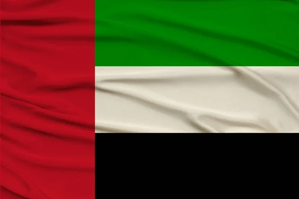 beautiful photograph colored national flag of modern state UAE on textured fabric, concept of tourism, emigration, economy and politics, close up