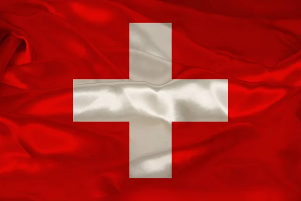 Foto av vackra färgade nationella flaggan i moderna staten Schweiz på texturerat tyg, begreppet turism, emigration, ekonomi och politik, närbild — Stockfoto