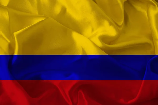 Fotografie frumoasă a steagului național colorat al statului modern Columbia pe o țesătură texturată, conceptul de turism, emigrație, economie și politică, closeup — Fotografie, imagine de stoc