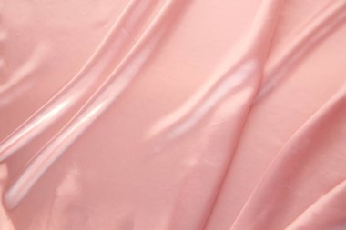 Küçük kıvrımlı, yumuşak akışlı, lüks, düğün konsepti, doku, arkaplan, bir kart için form, kopyalama alanı ile kaplı zarif pembe ipek kumaş.