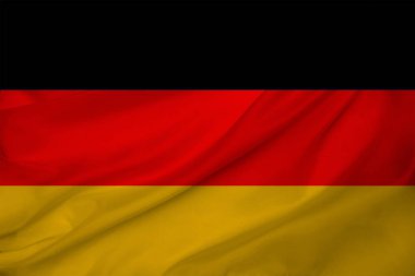 Modern Almanya 'nın renkli ulusal bayrağının dokulu kumaş, turizm, göç, ekonomi ve siyaset konsepti üzerindeki güzel fotoğrafı, yakın plan