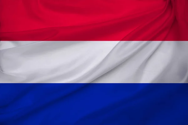 Foto der schönen farbigen Nationalflagge des modernen Staates der Niederlande auf Textilgewebe, Konzept des Tourismus, Wirtschaft und Politik, Nahaufnahme — Stockfoto