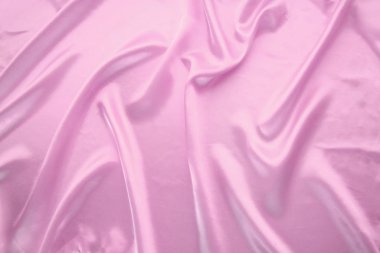 Küçük kıvrımlı, yumuşak akışlı, lüks, düğün konsepti, doku, arkaplan, bir kart için form, kopyalama alanı ile kaplı zarif pembe ipek kumaş.