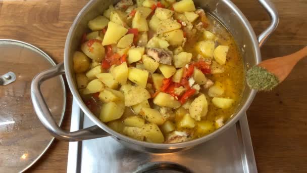 Housewife stirs ingredients with a wooden spatula delicious traditional Eintopf dish with meat and vegetables in a large metal pan, home cooking concept — Stock Footage Housewife Stirs Ingredients Wooden Spatula Delicious Traditional Eintopf Dish Meat Video Clip