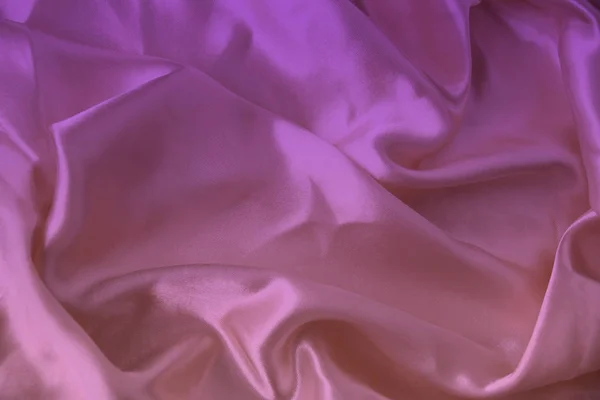 Belle texture de luxe de tissu drapé de soie avec des teintes de rose, violet, vue de dessus, gros plan, espace de copie — Photo