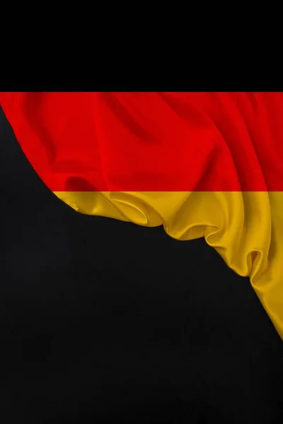 Vertical color national flag of modern state of Germany, beautiful silk, black blank form, concept of tourism, economy, politics, emigration, independence day, copy space, template — Stock Photo, Image