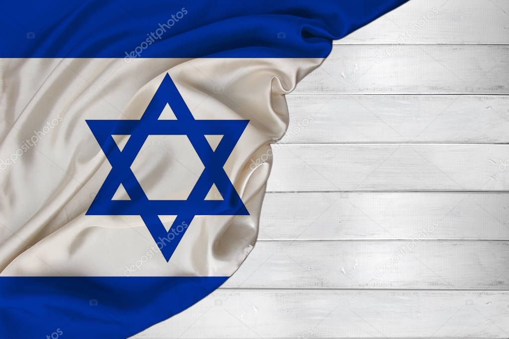 horizontal color national flag of modern state of Israel, beautiful silk, white wood background, concept of tourism, economy, politics, emigration, independence day, copy space, template