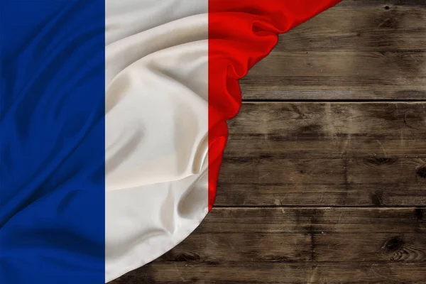 Color national flag of modern state of France, beautiful silk, background old wood, concept of tourism, economy, politics, emigration, independence day, copy space, template, horizontal — Stockfoto