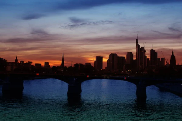 Вечером европейский город Франкфурт с мостами и рекой, с красивым закатом неба, городской пейзаж — стоковое фото