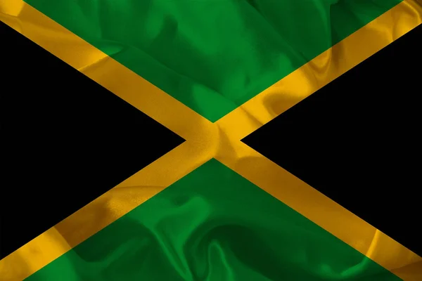 Έγχρωμη εθνική σημαία του σύγχρονου κράτους της Τζαμάικα σχετικά με όμορφο πλισέ ύφασμα από μετάξι, έννοια του τουρισμού, οικονομική και πολιτική ανάπτυξη, παγκόσμια επιχείρηση — Φωτογραφία Αρχείου
