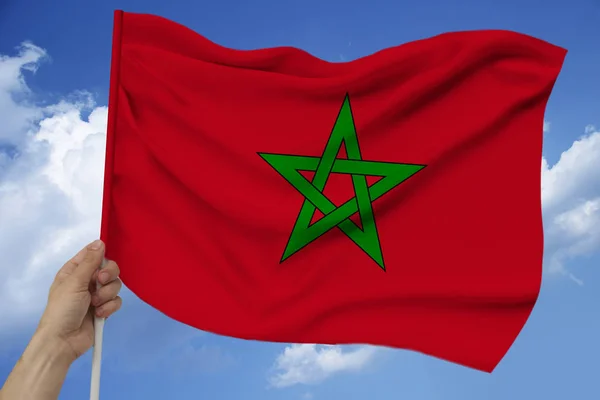 Photo of the beautiful colored national flag of the state of Morocco on textured fabric, concept of tourism, economics and politics, closeup — Stock Photo, Image