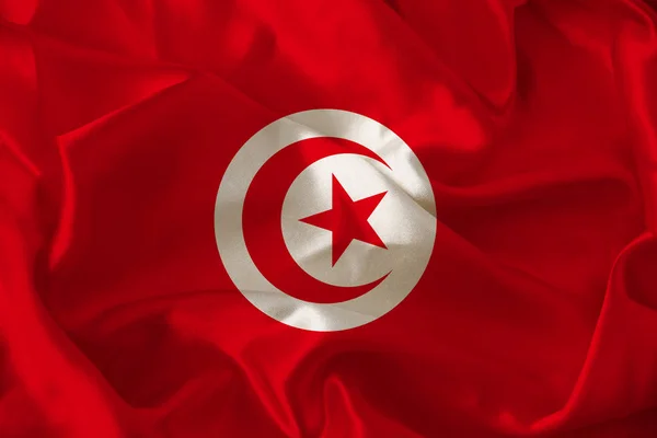 Fotografia da bela bandeira nacional colorida do moderno estado africano da Tunísia em tecido texturizado, conceito de turismo, emigração, economia e política, close-up — Fotografia de Stock