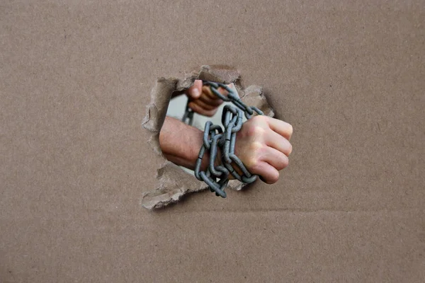 Male hands wrapped in a thick heavy iron chain, a symbol of the arrest of a criminal — Stock Photo, Image