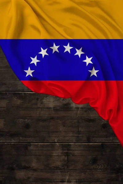 Vertical colored national flag of the modern state of Venezuela, beautiful silk, old wood background, concept of tourism, economy, politics, emigration, independence day, copy space, template — Stock Photo, Image