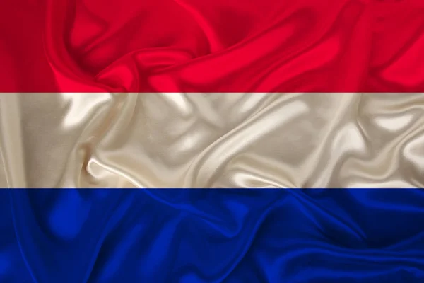 Nationale vlag van Nederland op zachte zijde met windvouwen, reisconcept, immigratie, politiek, kopieerruimte, close-up — Stockfoto