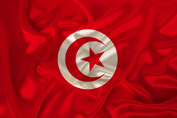 Photo du drapeau national de Tunisie sur une texture luxueuse de satin, soie avec vagues, plis et faits saillants, gros plan, espace de copie, illustration — Photo