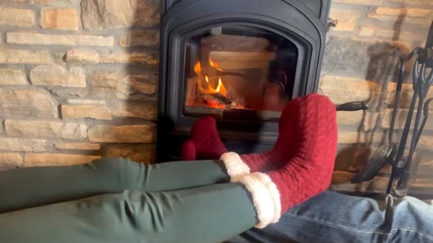Man Woman Lie Hot Burning Fireplace Legs Stretched Out Red — Stock Video