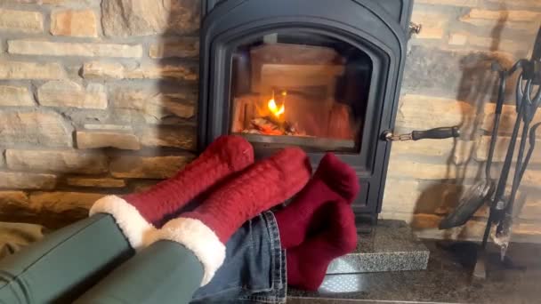 Man Woman Lie Hot Burning Fireplace Legs Stretched Out Red — Stock Video