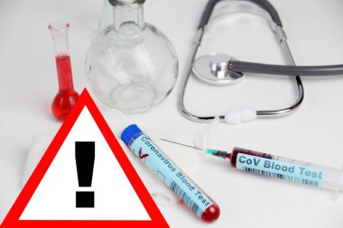 İçinde Coronavirus testi ve içinde kan olan şırınga, stetoskop, matara, Cov virüsünün yayılma tehlikesi olan tıbbi laboratuvar test tüpü.