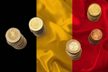 Belçika 'nın ulusal bayrağının arka planına, mali kalkınma, devalüasyon, enflasyon, vergiler kavramına karşı Eu para biriminin metal euro sikkeleri