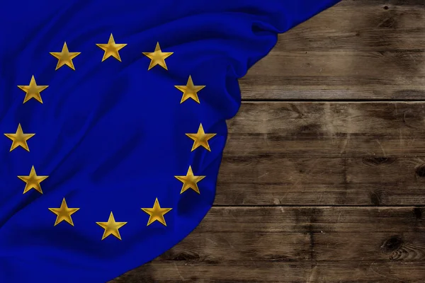 Color European Union flag, symbol of united Europe, beautiful silk, background old wood, concept of tourism, economy, politics, emigration, independence day, copy space, template, horizontal — 스톡 사진
