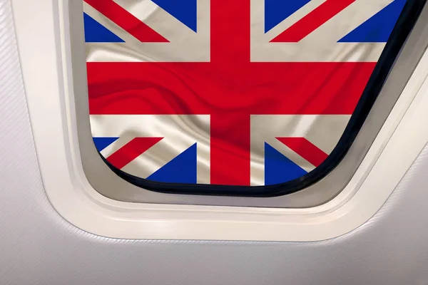 Nationalflagge des modernen britischen Staates im Bullauge eines Flugzeugs, Reisekonzept, Tourismus, Auswanderung — Stockfoto