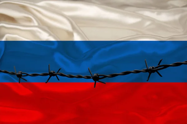Alambre de púas de hierro en el contexto de la bandera nacional de seda del estado de Rusia, el concepto de encarcelamiento para los delincuentes, para la zona de asedio — Foto de Stock