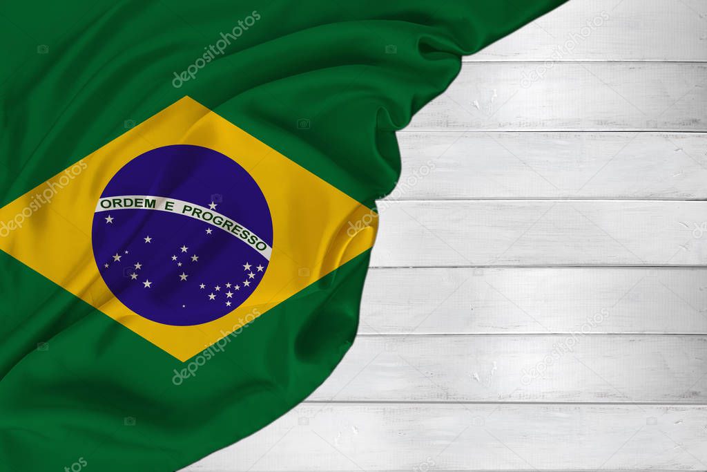 horizontal colored national flag of modern state of Brazil, beautiful silk, white wood background, concept of tourism, economy, politics, emigration, independence day, copy space, template
