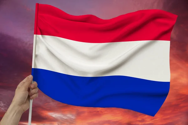 Photo of the beautiful colored national flag of the modern state of the Netherlands on textural fabric, concept of tourism, economics and politics, closeup — Stock Photo, Image
