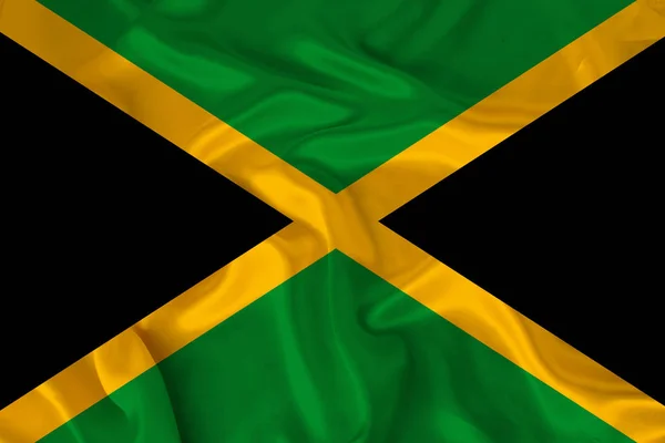 Foto van de nationale vlag van de staat Jamaica op een luxueuze textuur van satijn, zijde met golven, plooien en Highlights, close-up, kopieer ruimte, illustratie — Stockfoto