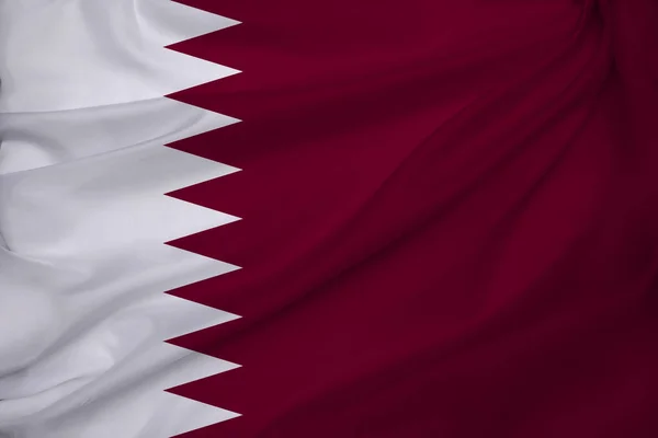 photo of the beautiful colored national flag of the modern state of Qatar on a textured fabric, concept of tourism, emigration, economy and politics