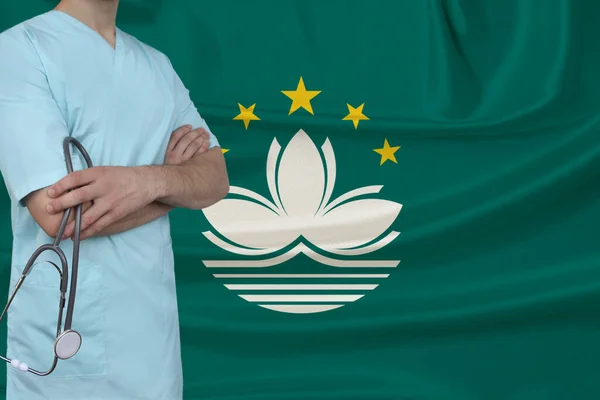 partial photograph of the doctor in uniform against the background of the Macau national flag on delicate shiny silk, the concept of medical care and insurance in the country, close-up, copy space