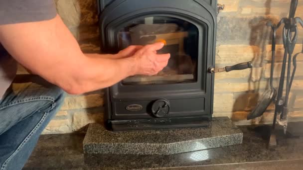 Man Warms His Hands Bright Orange Fire Black Fireplace Cozy — Stock Video