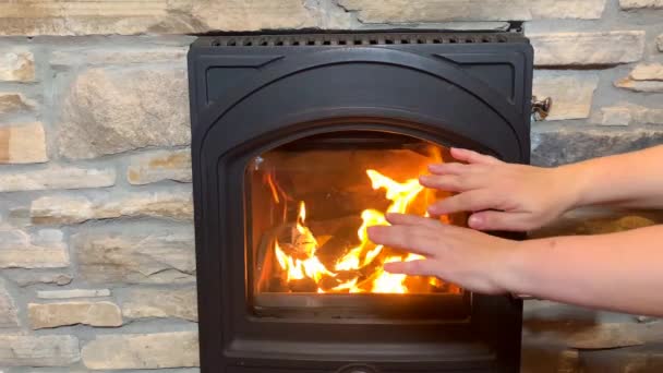 Man Woman Warms His Hands Bright Orange Fire Black Fireplace — Stock Video