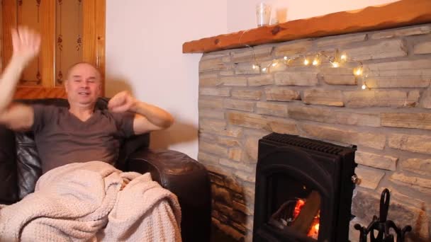 Middle Aged Man Sits Leather Sofa Burning Stone Enjoys Warmth — Stock Video