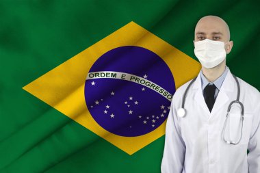 Brezilya 'nın ipek ulusal bayrağının arka planında steteskoplu erkek doktor, ulusal sağlık, sağlık, sigorta, turizm kavramı