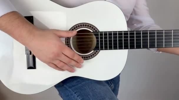穿着白衬衫的男人在家里弹六弦古典吉他 概念艺术 — 图库视频影像