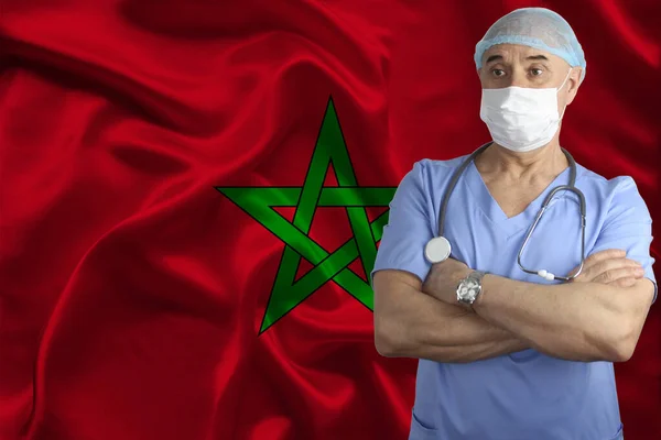 male doctor with a stethoscope on the background of the Morocco silk national flag, concept of national medical care, health, insurance, tourism