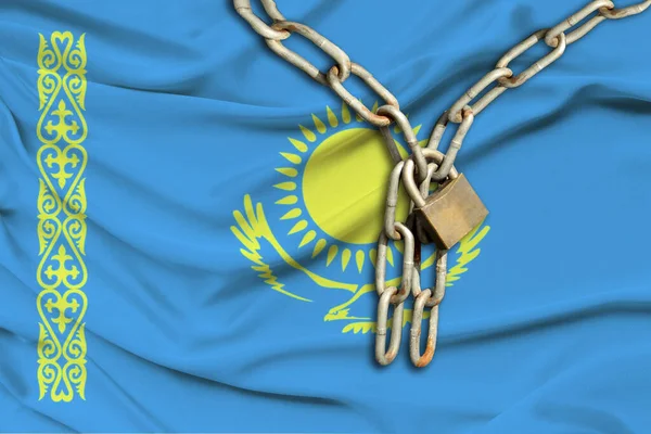 iron chain and lock on the silk national flag of Kazakhstan with beautiful folds, the concept of a ban on tourism, political repression, crime, violation of the rights and freedoms of citizens