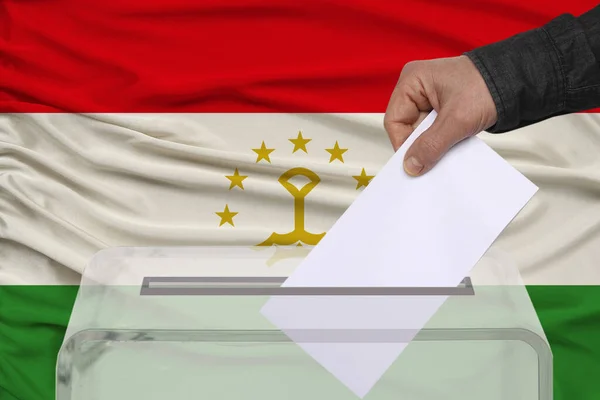투표자는 타지키스탄의 배경에 반대하는 함에서 투표용지를 낮춘다 — 스톡 사진