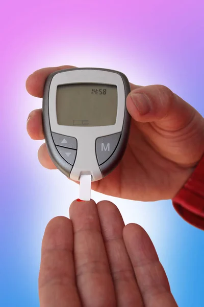 close up of man hands checking blood sugar level by Glucose meter for diabetes tester using as Medicine, glycemia, healthcare and medical concept